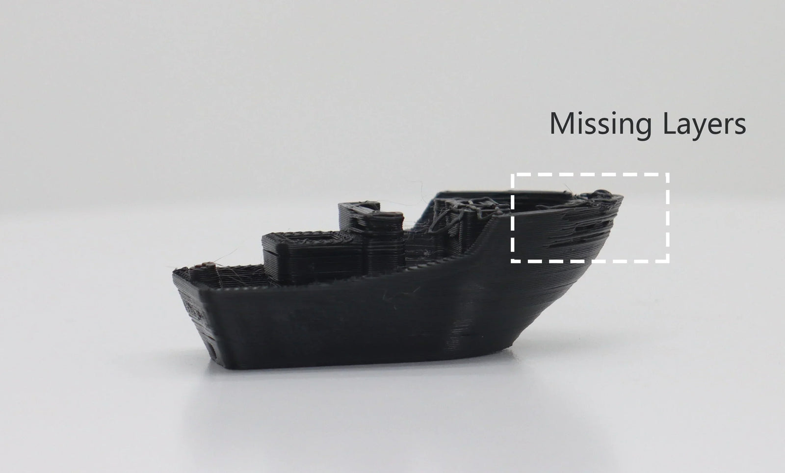 Schwarzes 3D-Benchy-Modell mit einem hervorgehobenen Bereich, der fehlende Schichten am Rumpf zeigt und Underextrusion-Druckfehler veranschaulicht.